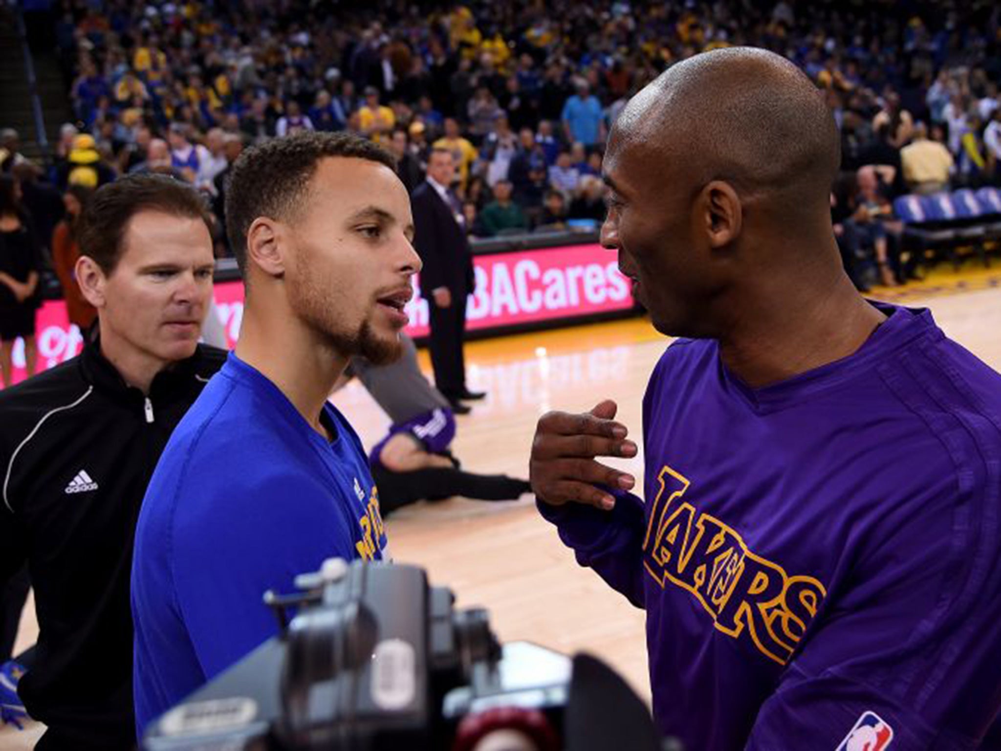 Steph Curry (left), of the Golden State Warriors, and Los Angeles Lakers’ Kobe Bryant chat before their NBA game in Oakland last month