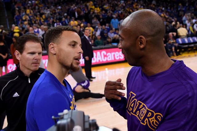 Steph Curry (left), of the Golden State Warriors, and Los Angeles Lakers’ Kobe Bryant chat before their NBA game in Oakland last month