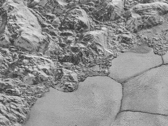 In this highest-resolution image from NASA’s New Horizons spacecraft, great blocks of Pluto’s water-ice crust appear jammed together in the informally named al-Idrisi mountains.