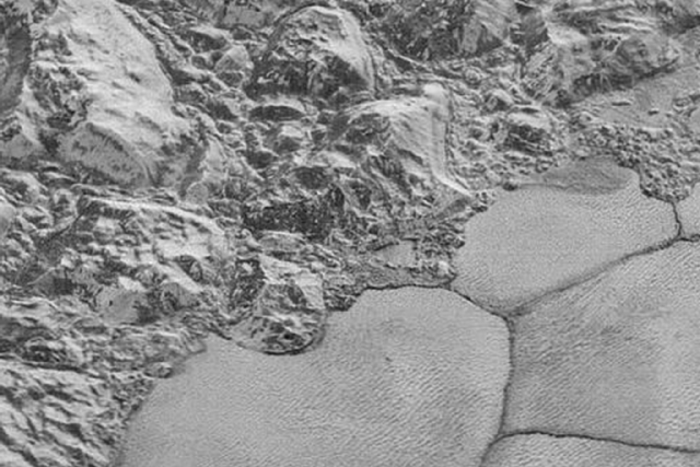 In this highest-resolution image from NASA’s New Horizons spacecraft, great blocks of Pluto’s water-ice crust appear jammed together in the informally named al-Idrisi mountains.