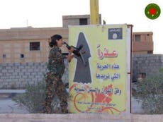 Female Kurdish fighter destroying Isis sign is the picture of defiance