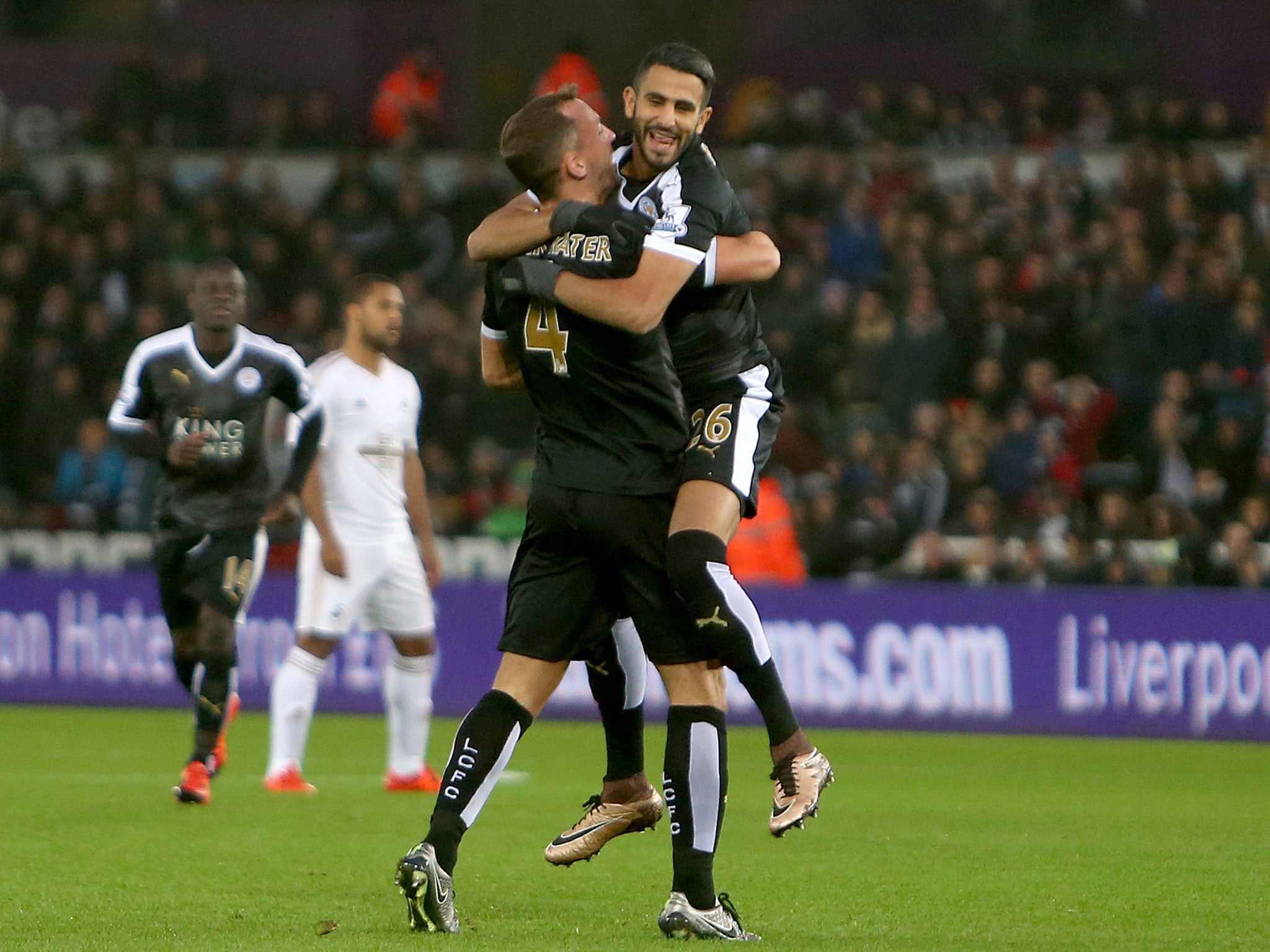 Riyad Mahrez celebrates with Danny Drinkwater after giving Leicester the lead over Swansea