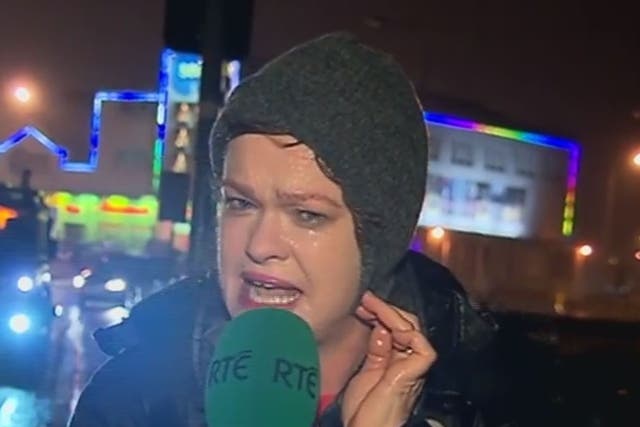TV presenter Teresa Mannion braces herself in the middle of Storm Desmond