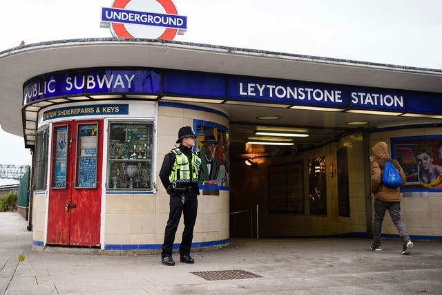 police officer stands guard outside Leytonstone station in east London on December 6, 2015, a day after three people were stabbed in what police are treating as a 'terrorist incident'
