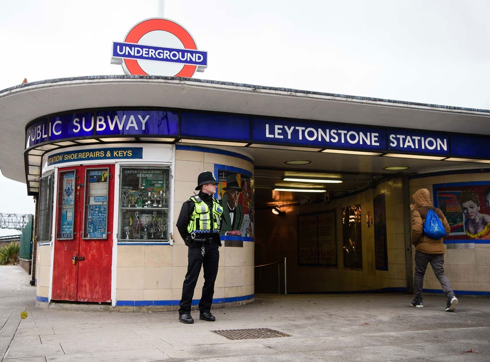A police officer stands guard outside Leytonstone station in north London on December 6, 2015, a day after three people were stabbed in what police are treating as a 'terrorist incident'