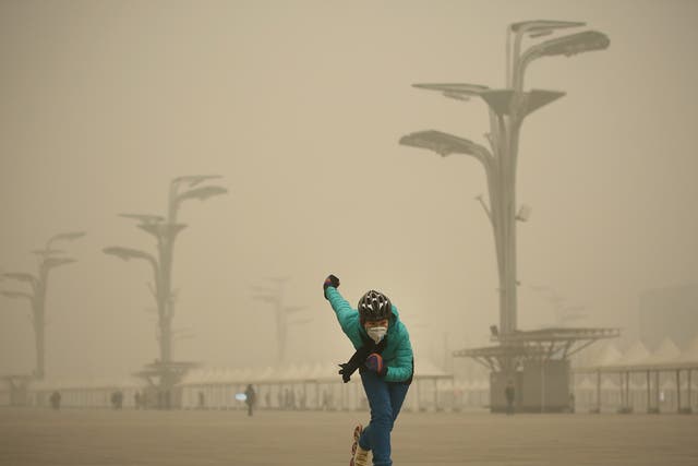 A rollerblader dons a mask to practise at Beijing’s Olympic Park