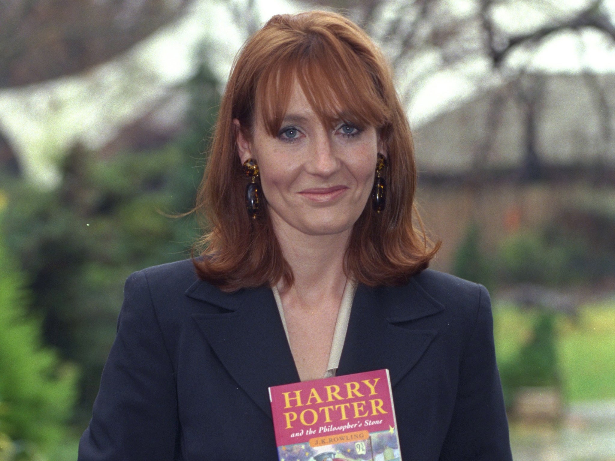 JK Rowling with her first Harry Potter book in 1997