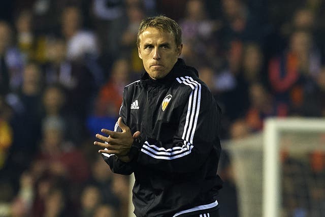 Phil Neville applauds Valencia’s players after the 1-1 draw with Barcelona