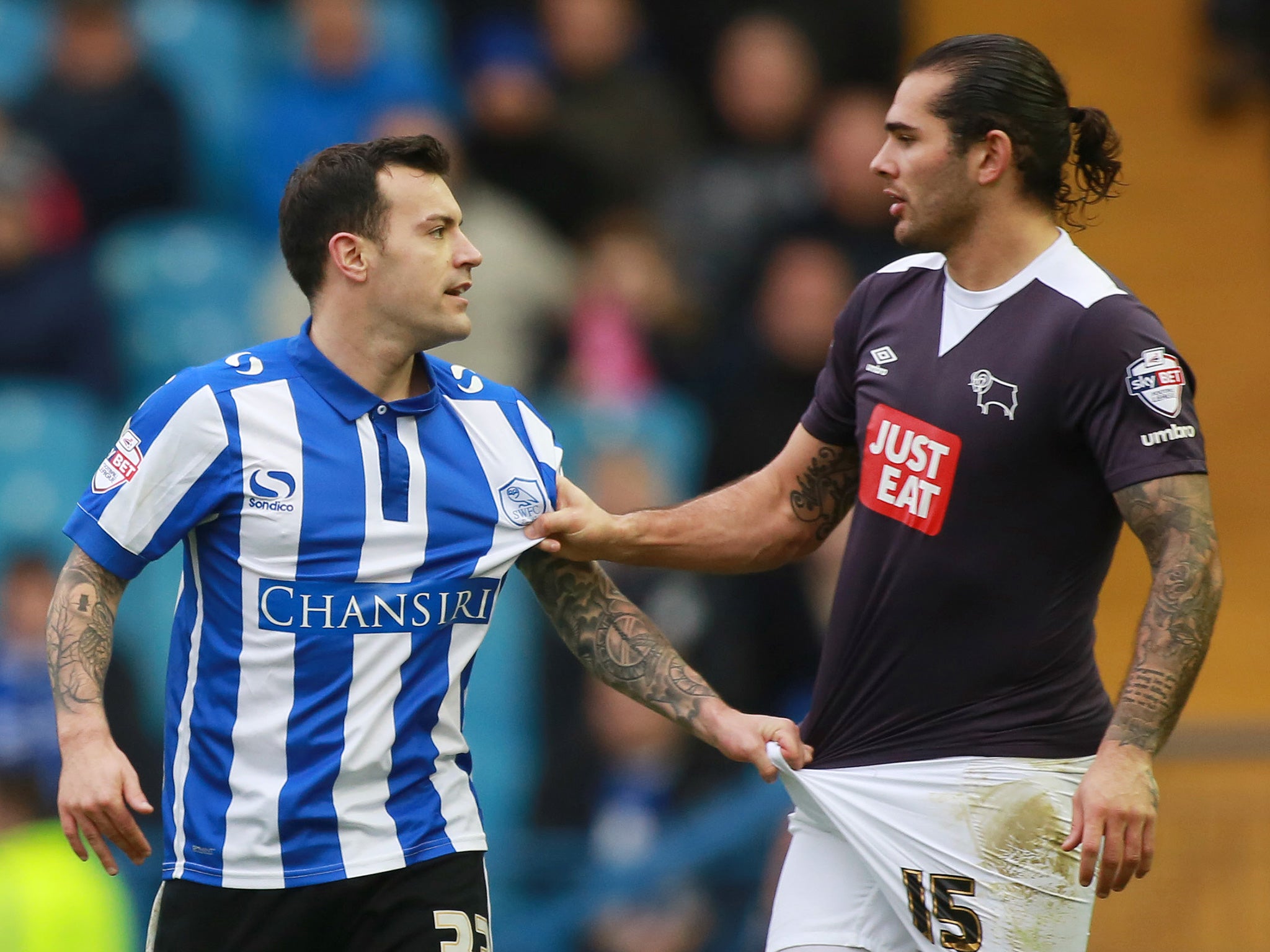 Sheffield Wednesday’s Ross Wallace, left, argues with the Derby County midfielder Bradley Johnson