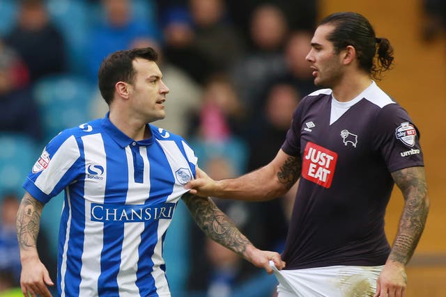 Sheffield Wednesday’s Ross Wallace, left, argues with the Derby County midfielder Bradley Johnson