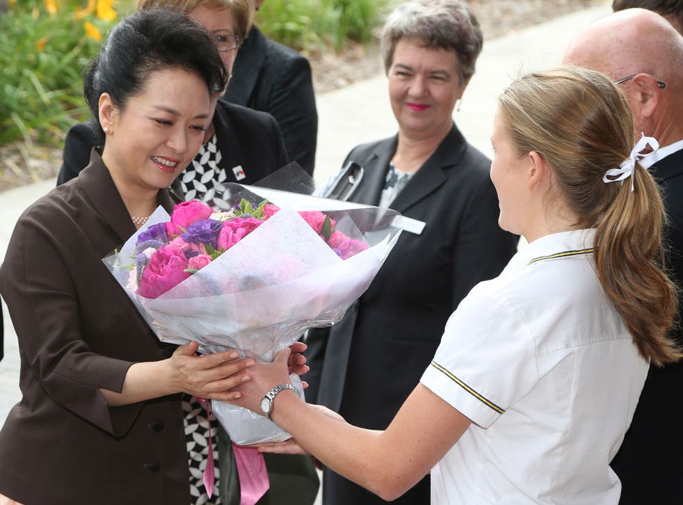 Sarah Haynes presenting Chinese President's Xi Jinping's wife,  Peng Liyuan, with flowers as she visited  Ravenswood School for Girls in November 2014