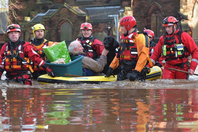 A rescue team helps to evacuate people from their homes after Storm Desmond caused flooding in Carlisle. Storm Desmond has brought severe disruption to areas of northern England as dozens of flood warnings remain in place