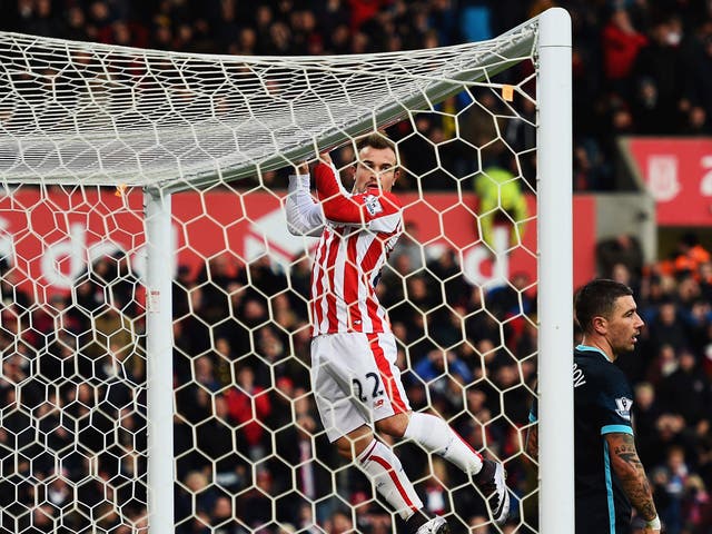 Stoke winger Xherdan Shqiri holds onto the crossbar during the win over Manchester City