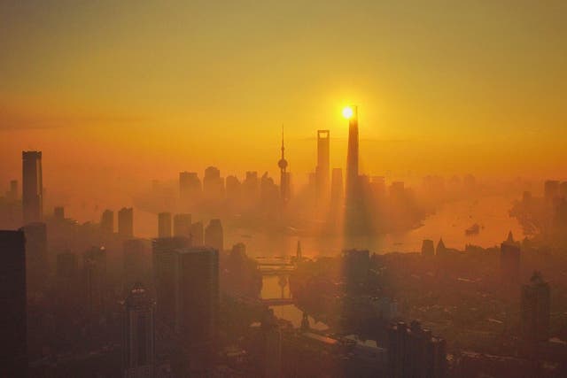 Skyscrapers and high-rise buildings in Pudong at sunrise in heavy smog in Shanghai