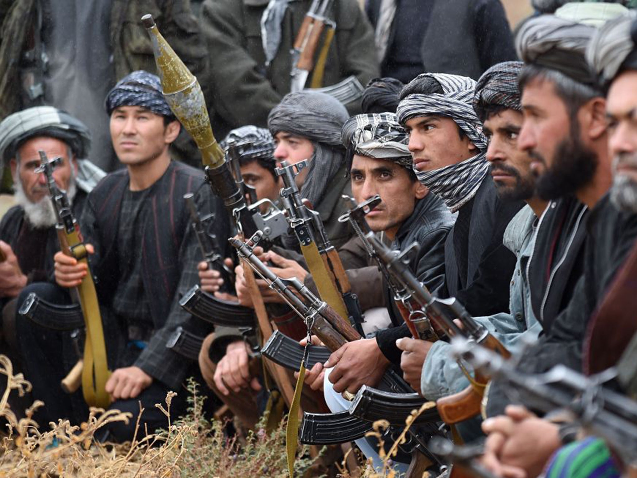 Members of an anti-Taliban militia meet to discuss tactics, but Afghan army forces are disorganised and often go unpaid