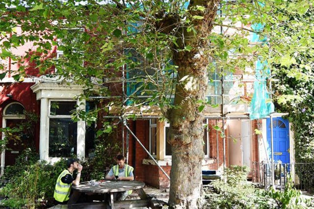 Builders taking a break outside one of the houses designed by the Turner Prize-winning Assemble collective in Cairns Street, part of the Granby Four Streets area in Liverpool