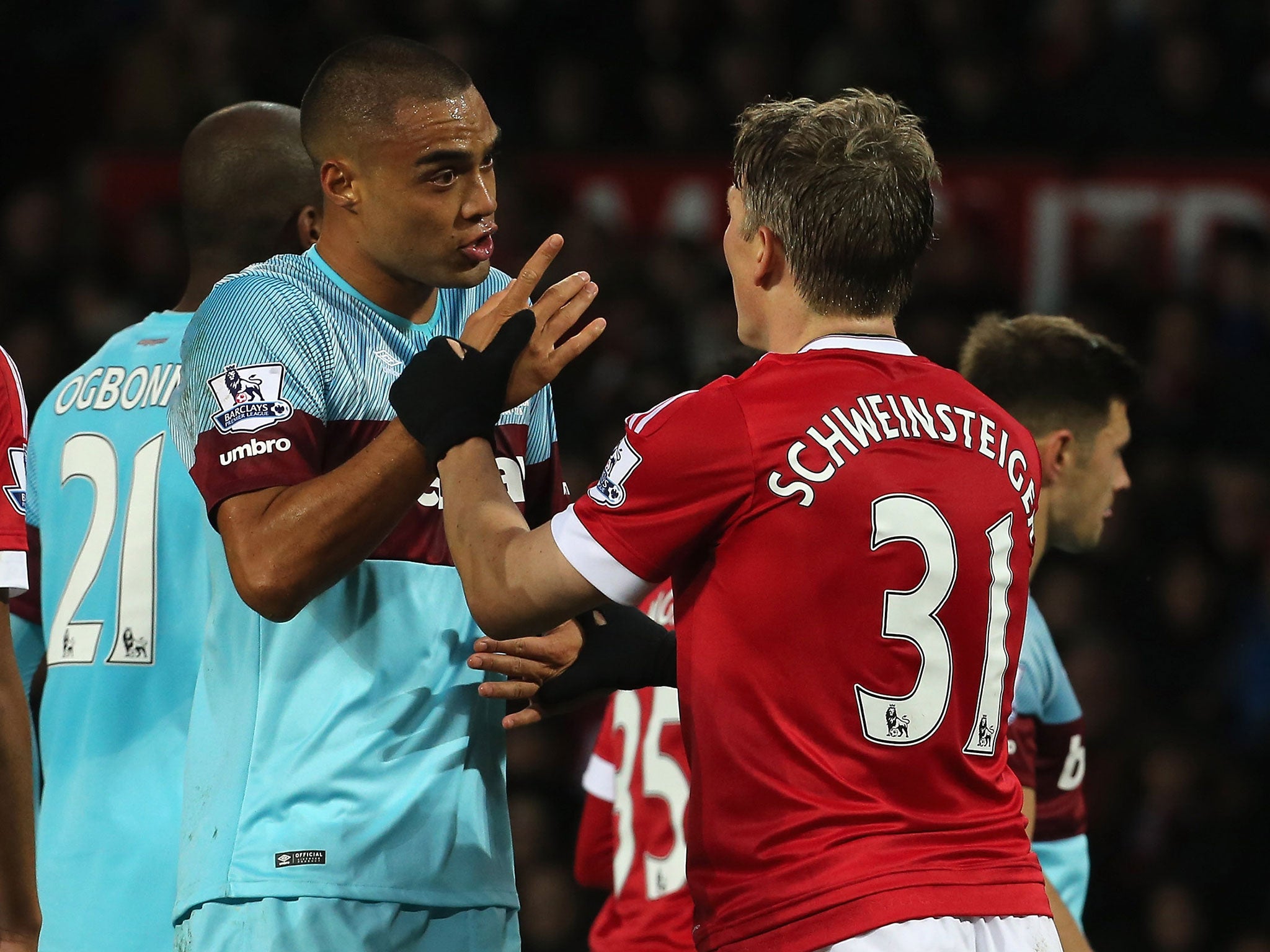 Manchester United midfielder Bastian Schweinsteiger clashes with West Ham's Winston Reid