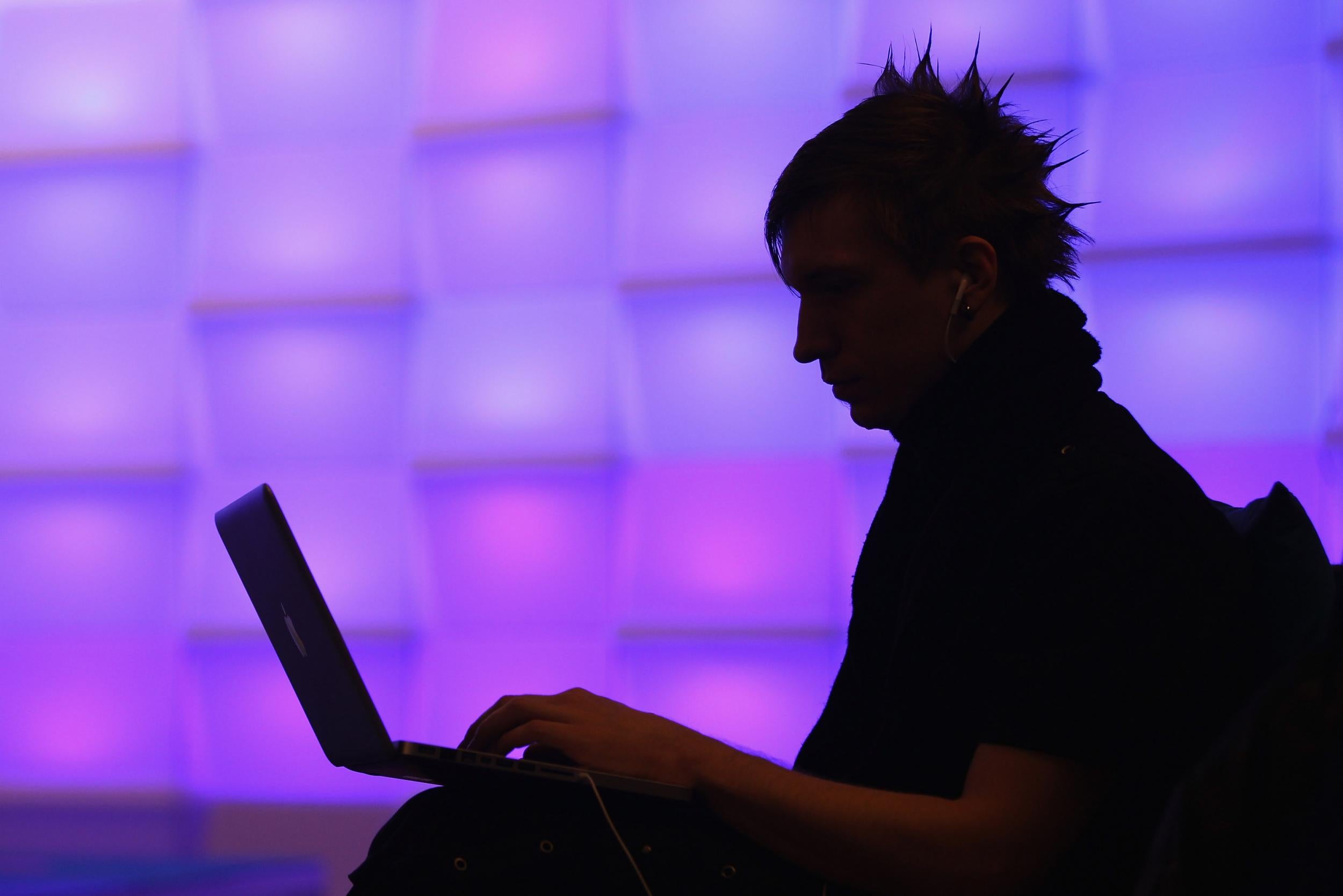 A participant uses his laptop at the annual Chaos Communication Congress, a hacker convention, in Berlin in 2010