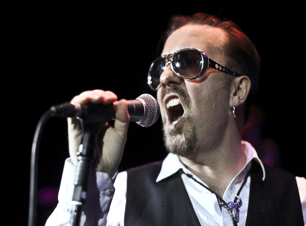 Ricky Gervais on stage in character as aspiring rock star David Brent