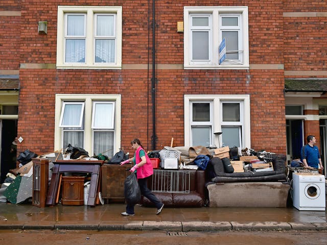 Residents empty their possessions from their homes in Carlisle