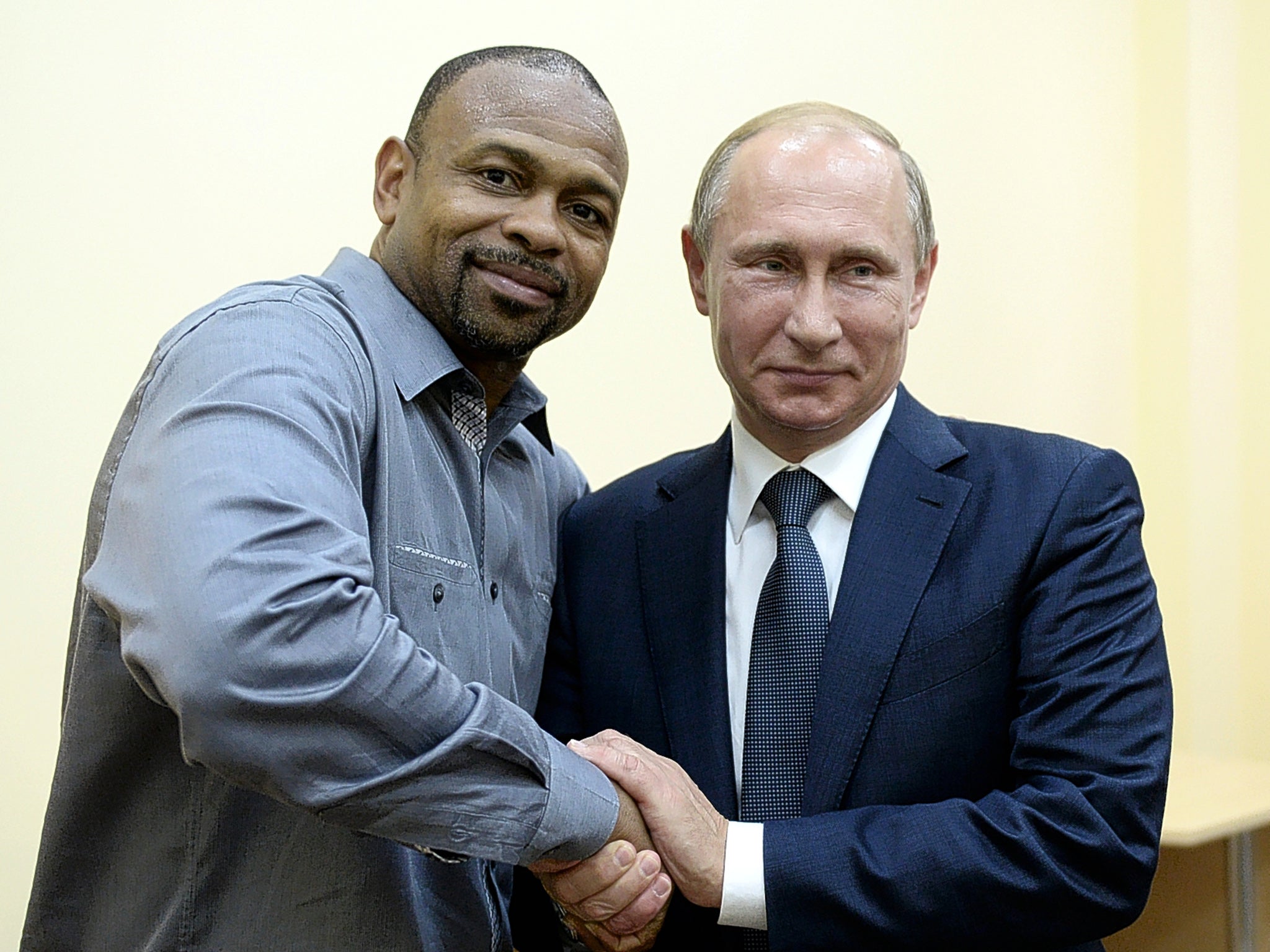 Roy Jones shakes hands with Russia’s President Vladimir Putin in August