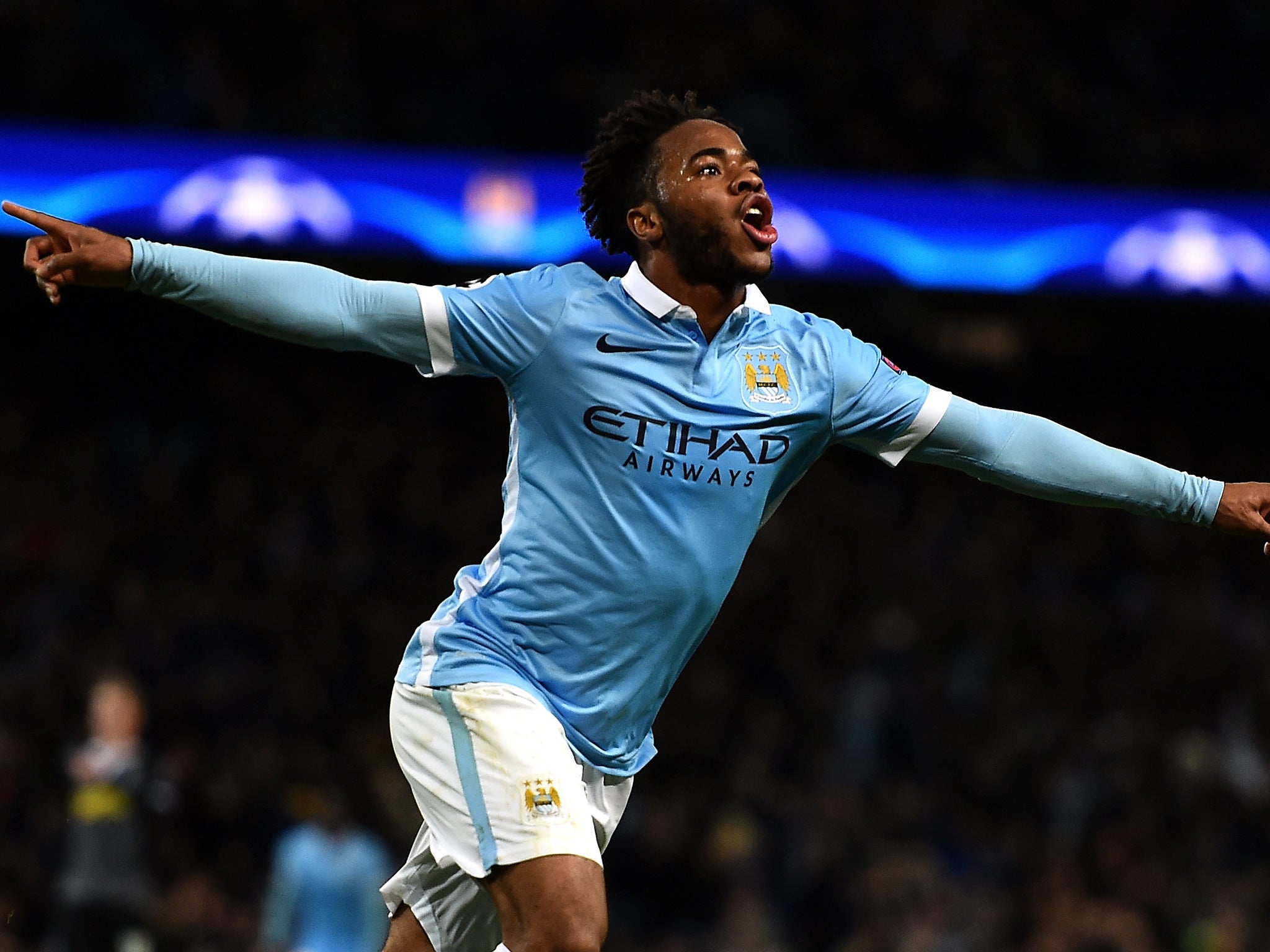Raheem Sterling celebrates after scoring Manchester City's third