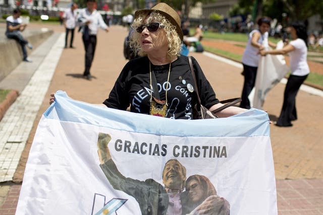 A government supporter pays tribute to President Cristina Fernandez de Kirchner and her husband, the late President Nestor Kirchner, in Buenos Aires