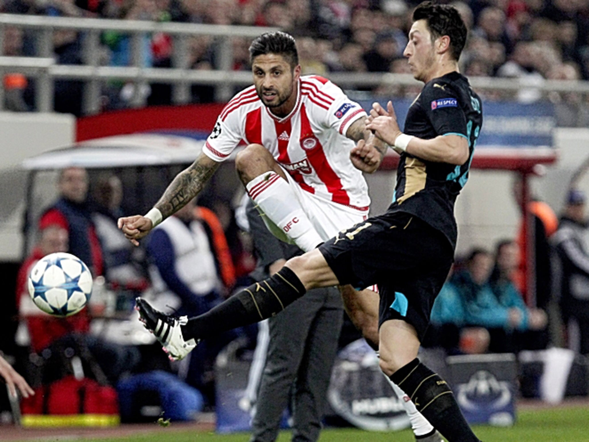 Mesut Özil (right) tussles with Manuel da Costa – the Arsenal player’s pass to set up the opening goal turned the night