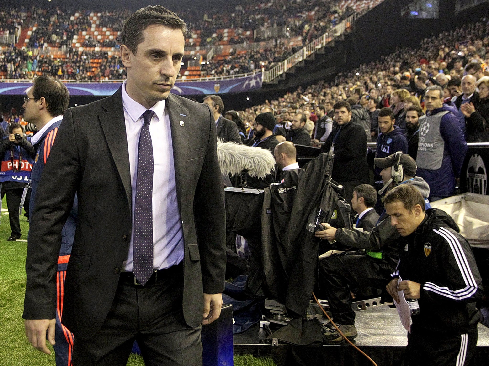 A glum-looking Gary Neville at the Mestalla last night with his brother Phil on the Valencia bench