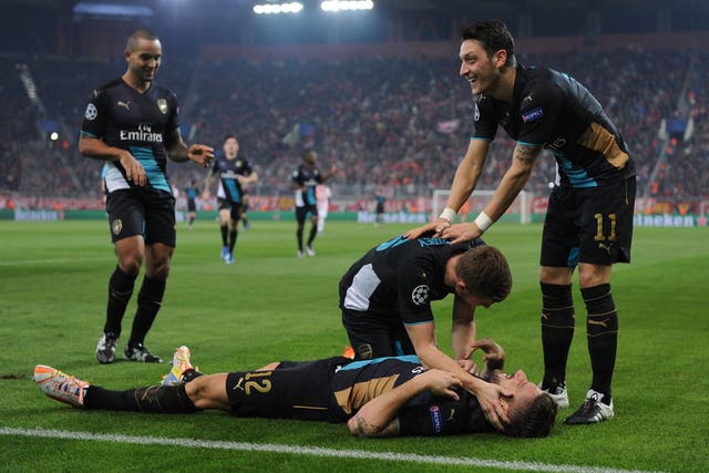 Olivier Giroud is congratulated by his Arsenal team-mates