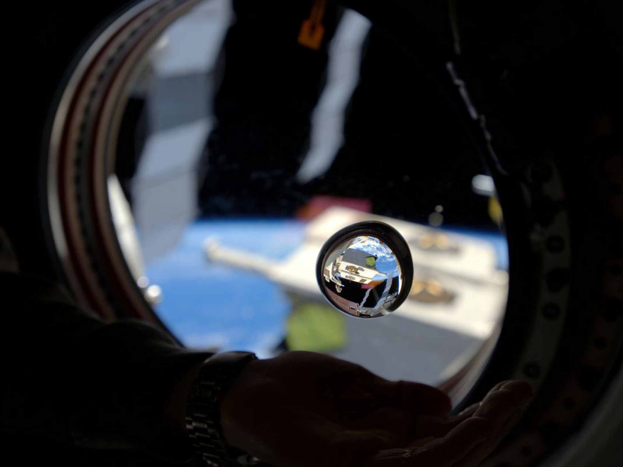 Alcohol is barred on the ISS, but you won't escape daft initiations – such as drinking a blob of floating water (NASA)