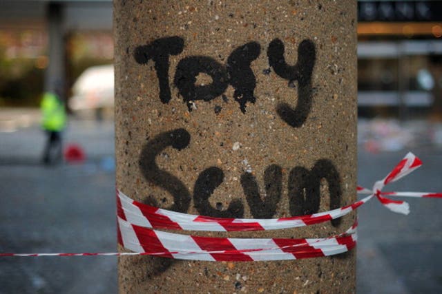 Graffiti on a pillar outside of the damaged Conservative Party HQ in 2010 when students stormed the building in protest over plans to increase tuition fees, branding David Cameron ‘completely unacceptable’