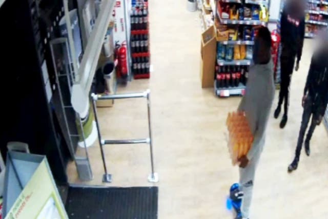 The man on the hoverboard appears to leave the store without paying for the crate of Lucozade
