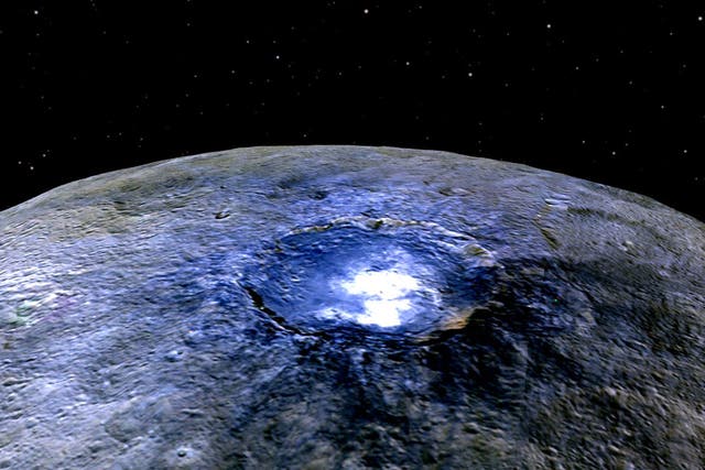 This representation of Ceres' Occator Crater in false colours shows differences in the surface composition. Scientists use the false colour as a way of examining the way that the surface is composed