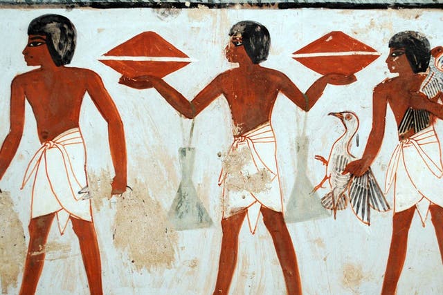 A porter carrying two containers of honey in the tomb of Menna