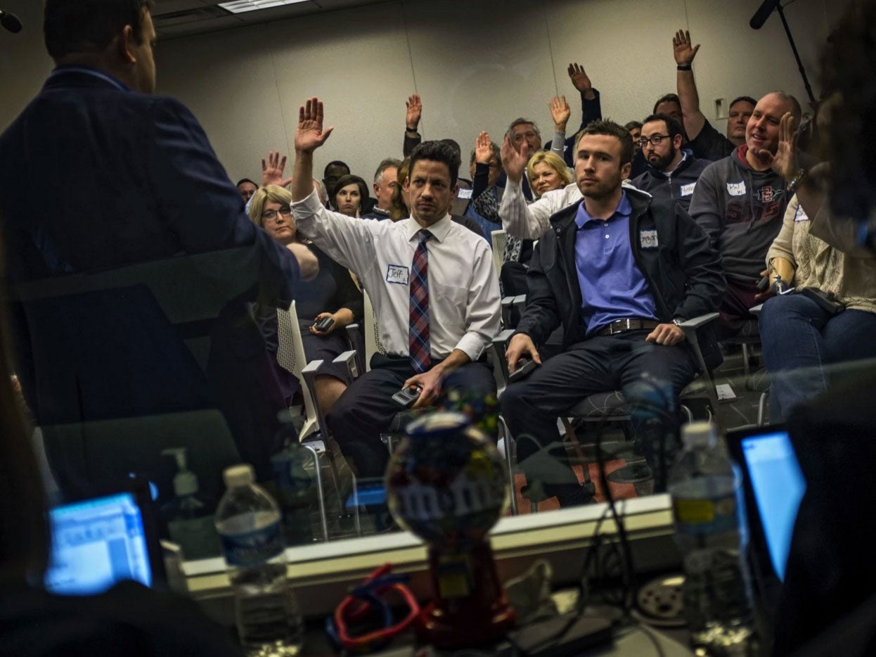 Through a one-way mirror, journalists observe a focus group of Donald Trump