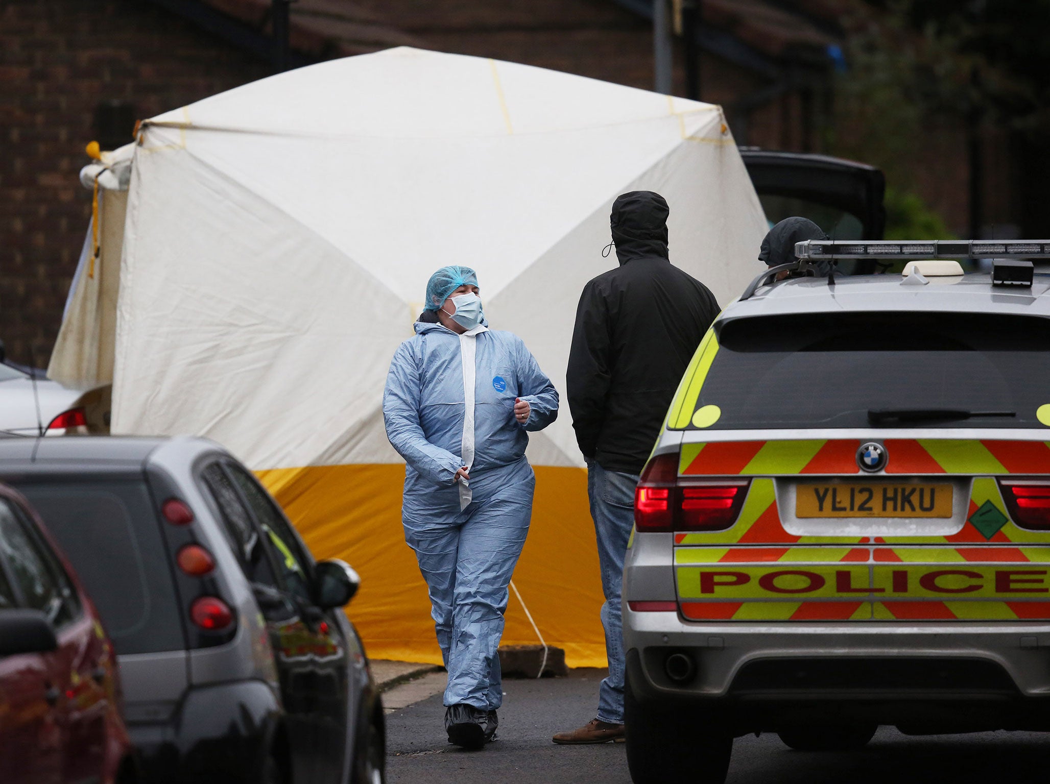 A police forensics officer walks past a forensics tent covering the body of a man who was shot by police officers on December 11, 2015 in Wood Green, London, England