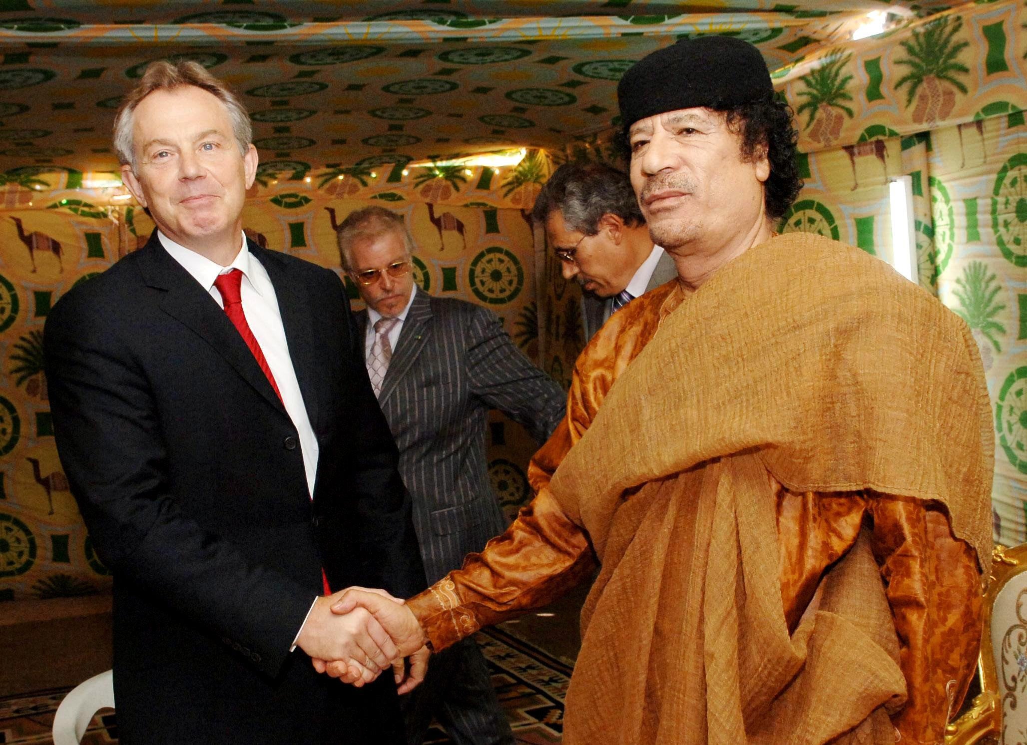 Tony Blair and Colonel Gaddafi shake hands during the famous 2004 'deal in the desert'