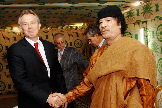 Tony Blair and Colonel Gaddafi shake hands during the famous 2004 'deal in the desert'