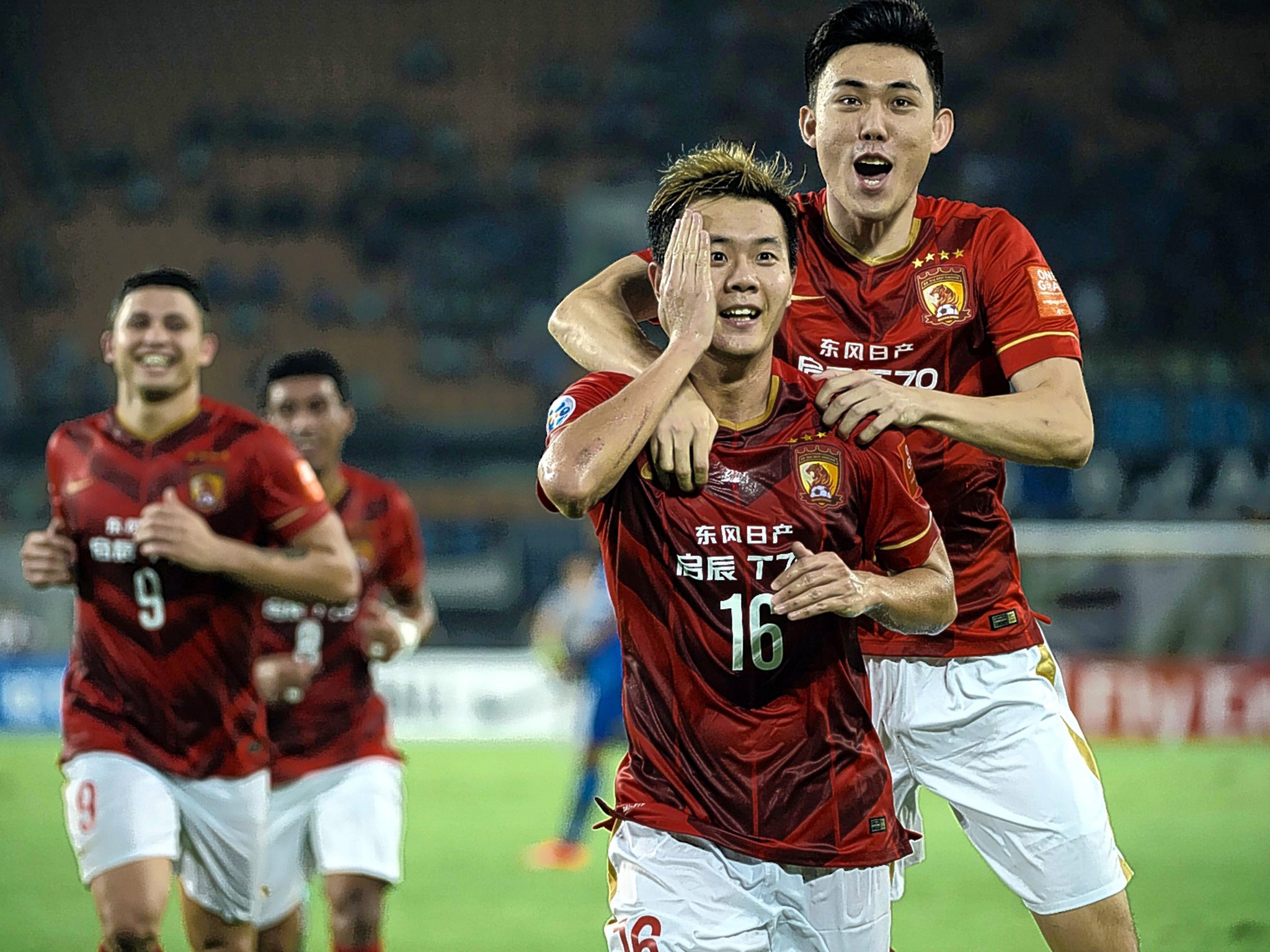 Huang Bowen (second right) celebrates a goal during Guangzhou  Evergrande Taobao’s successful Asian Champions League campaign