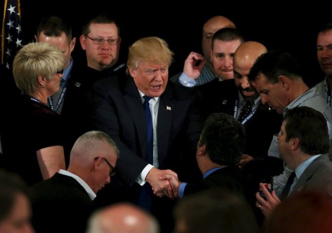 U.S. Republican presidential candidate Donald Trump shakes hands with people after receiving an endorsement at the meeting of the New England Police Benevolent Association in Portsmouth, New Hampshire.