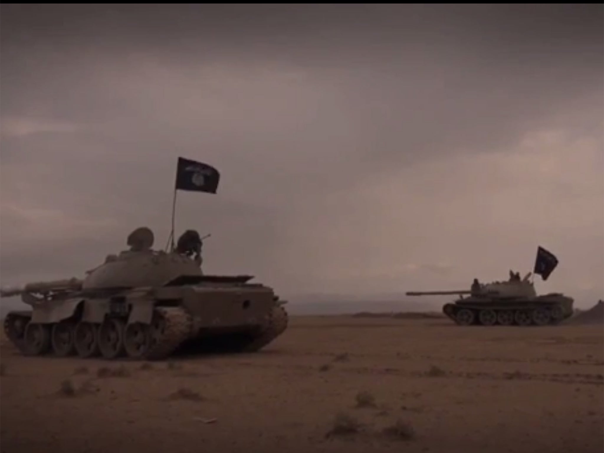 The video shows tanks displaying the black of Isis moving through the desert