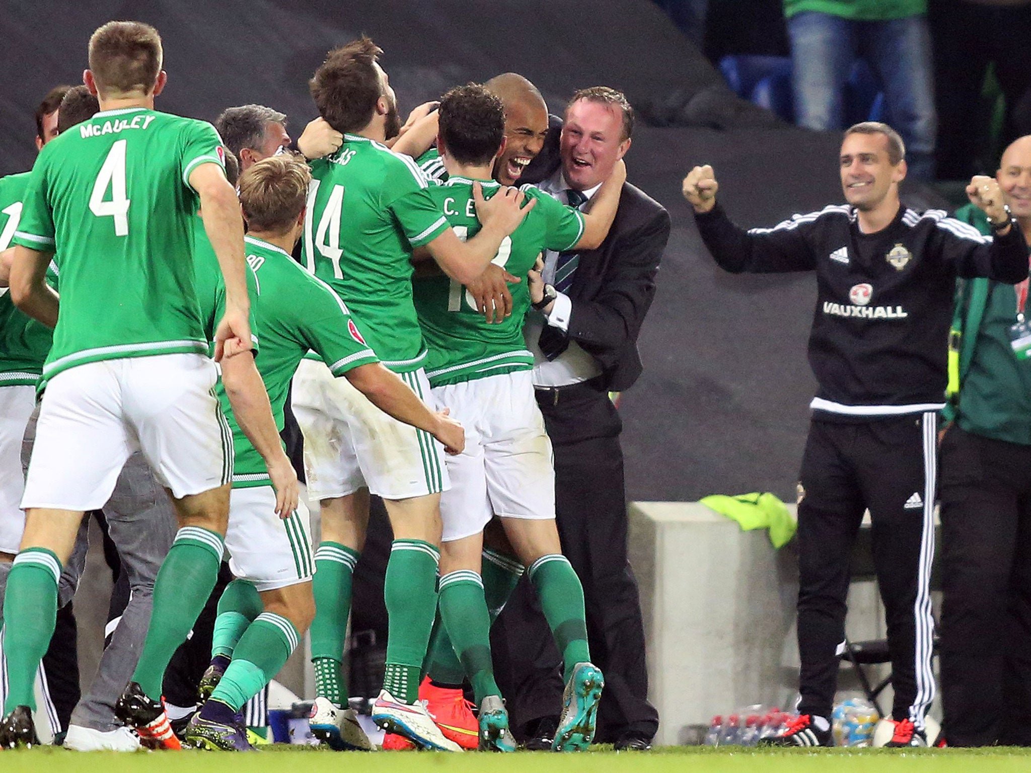 Michael O'Neill celebrates with his players during qualification