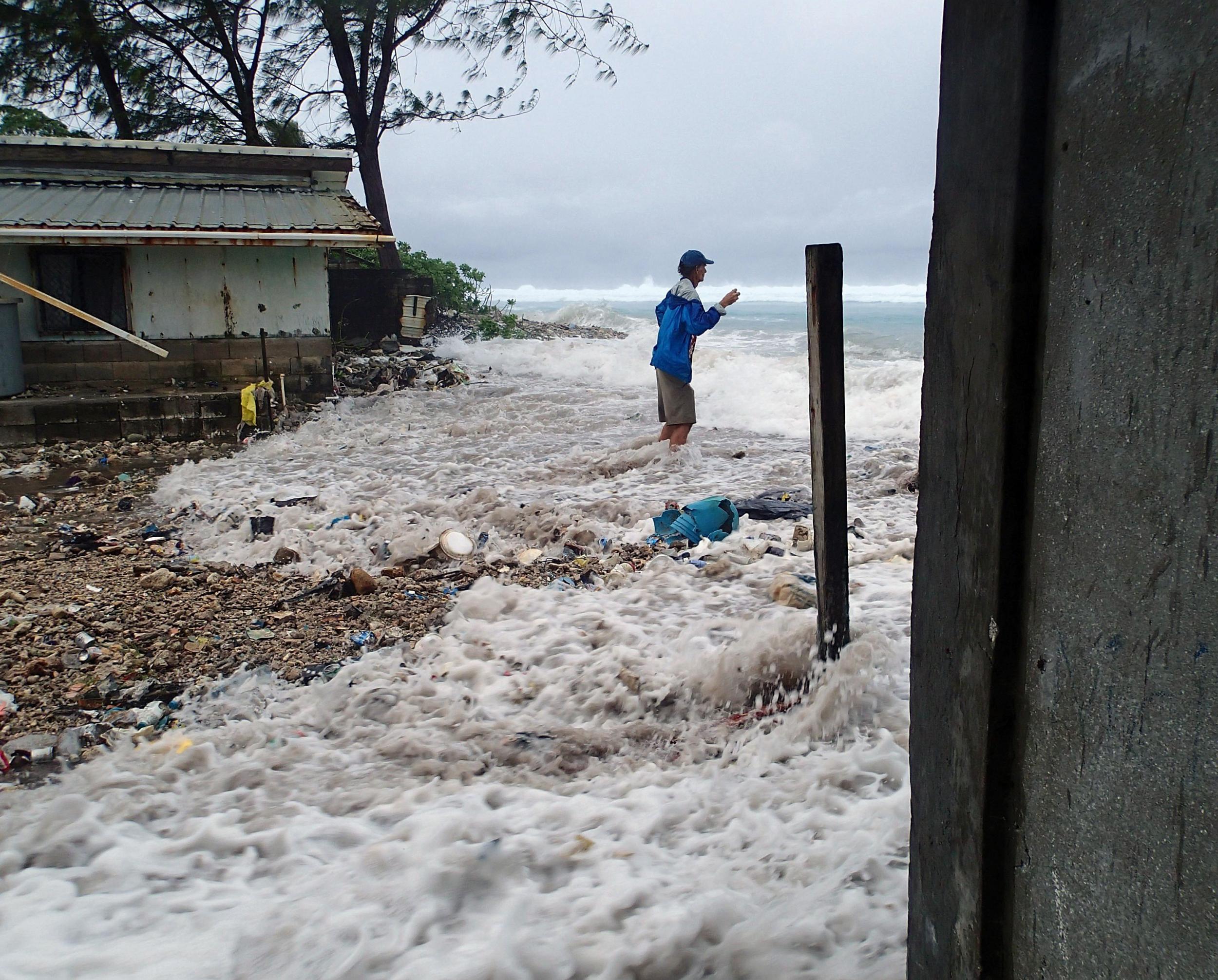 A storm surge of the Marshall Island of Majuro in 2014 which damaged homes - it was the third of its kind in just 12 months.