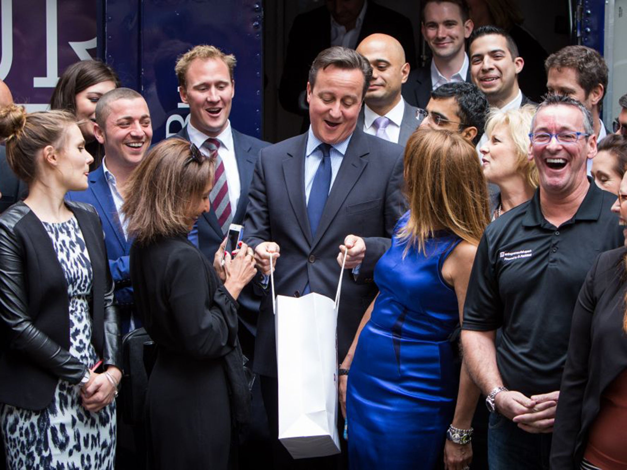 Prime Minister David Cameron receives a gift from mentors and supporters from StartUp Britain, a national campaign by Britain's leading business people to support businesses across the UK