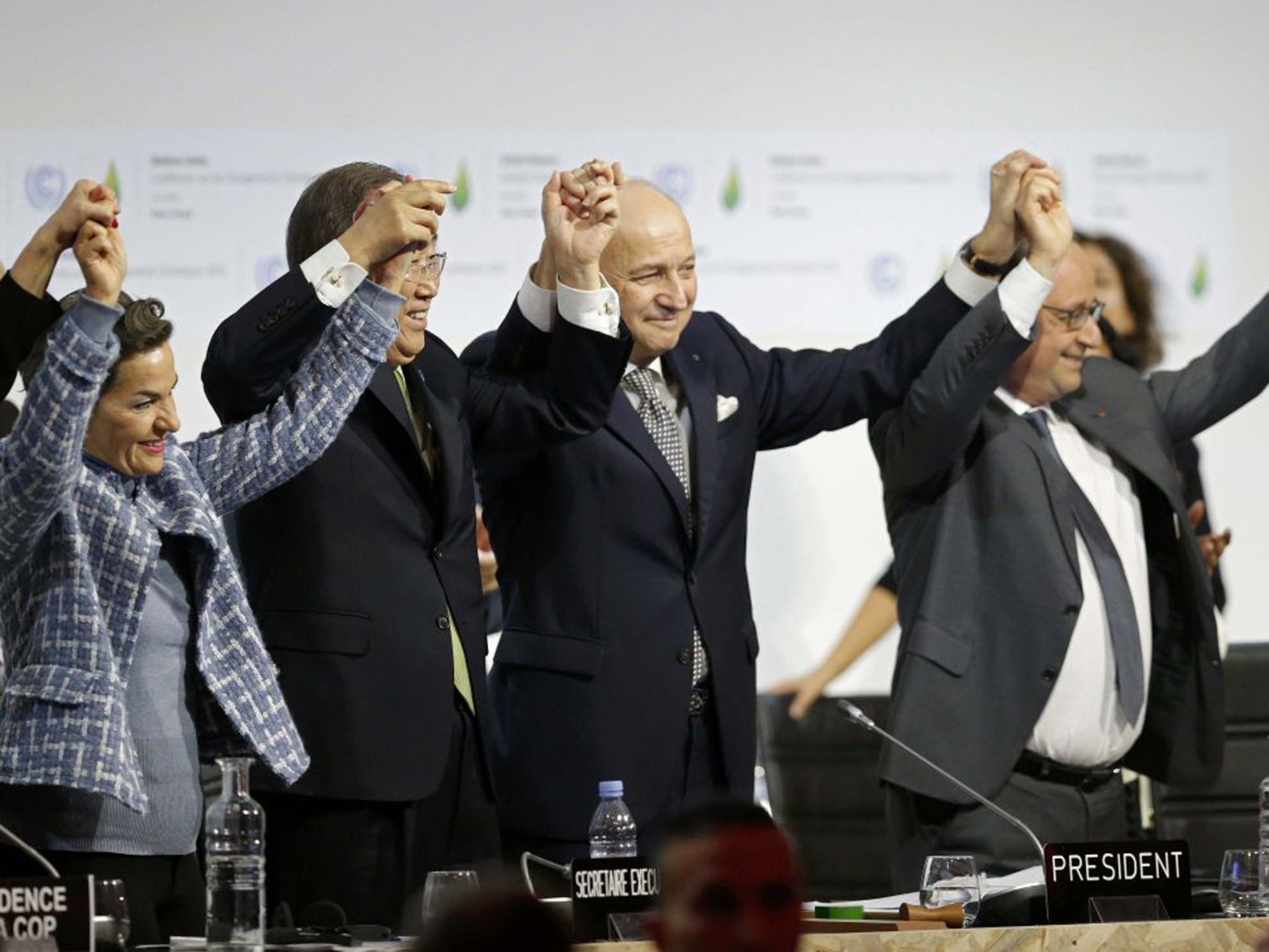 From Left to right: Christiana Figueres, Executive Secretary of the UN Framework Convention on Climate Change; UN Secretary-General Ban Ki-moon; French Foreign Affairs Minister and President-designate of the summit Laurent Fabius; and French President Francois Hollande celebrate the closing of the final plenary session at the World Climate Change Conference 2015