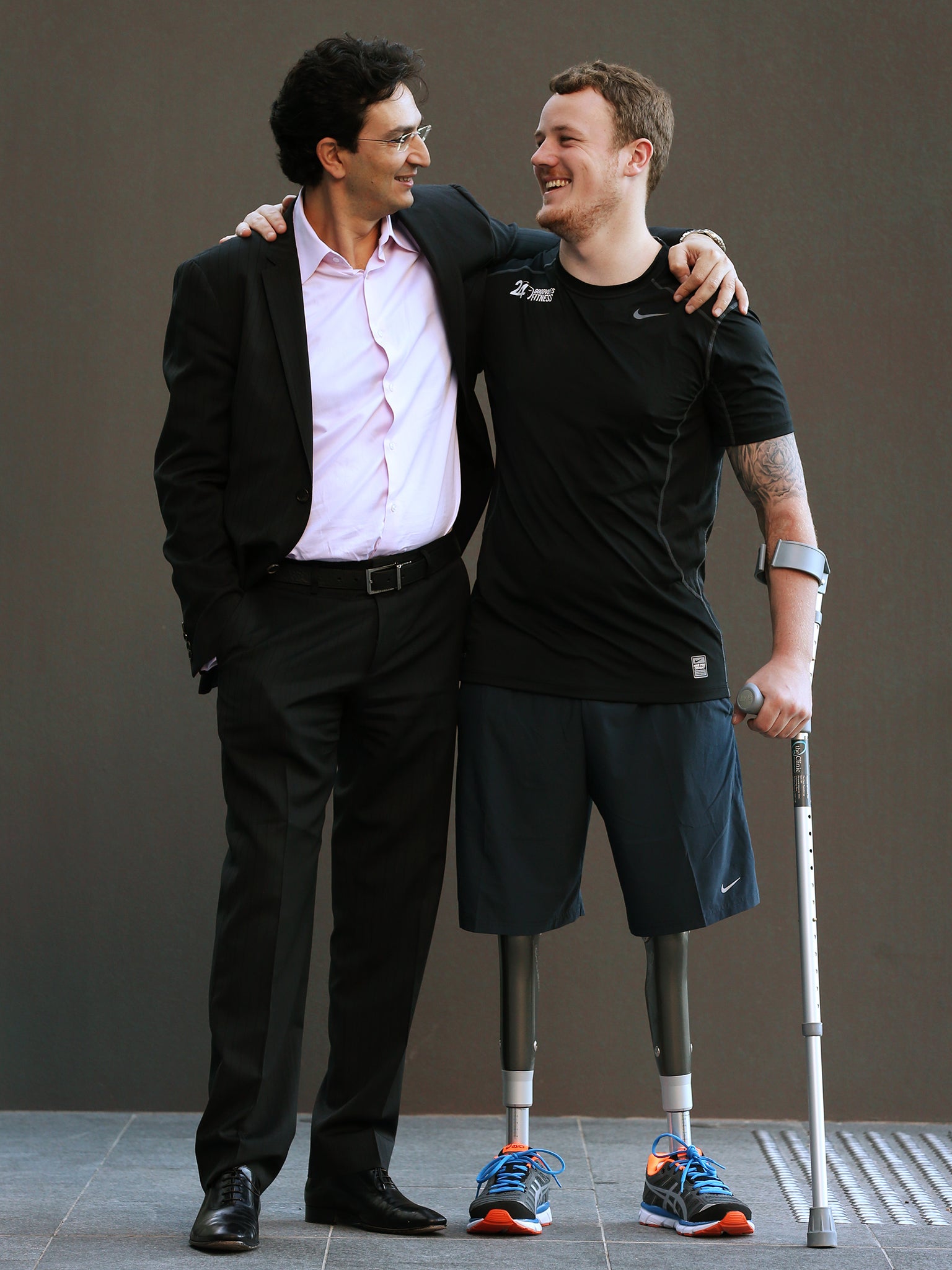 Dr Munjed Al Muderis, left, performed the the osseointegration procedure on amputee Michael Swain, right