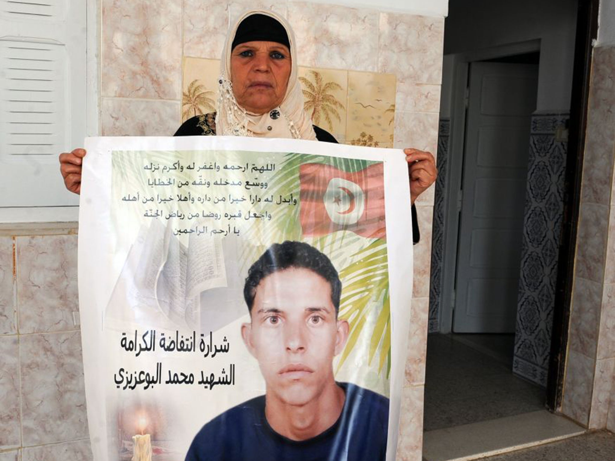 Mannoubia Bouazizi with an image of her son Mohammed