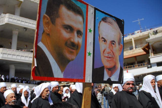Supporters with a poster of Bashar al-Assad and his father, Hafez