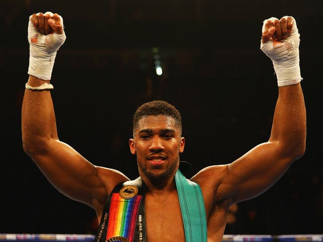 Anthony Joshua celebrates his victory over Dillian Whyte